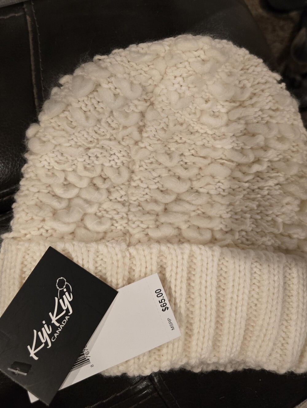 Kyi Kyi knit beanie featuring a cozy foldover cuff and a textured loop design.